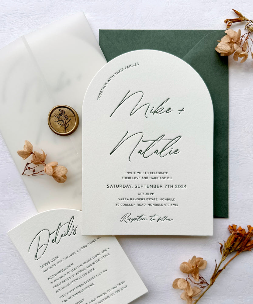 Minimalist letterpress arch wedding invitation in green.