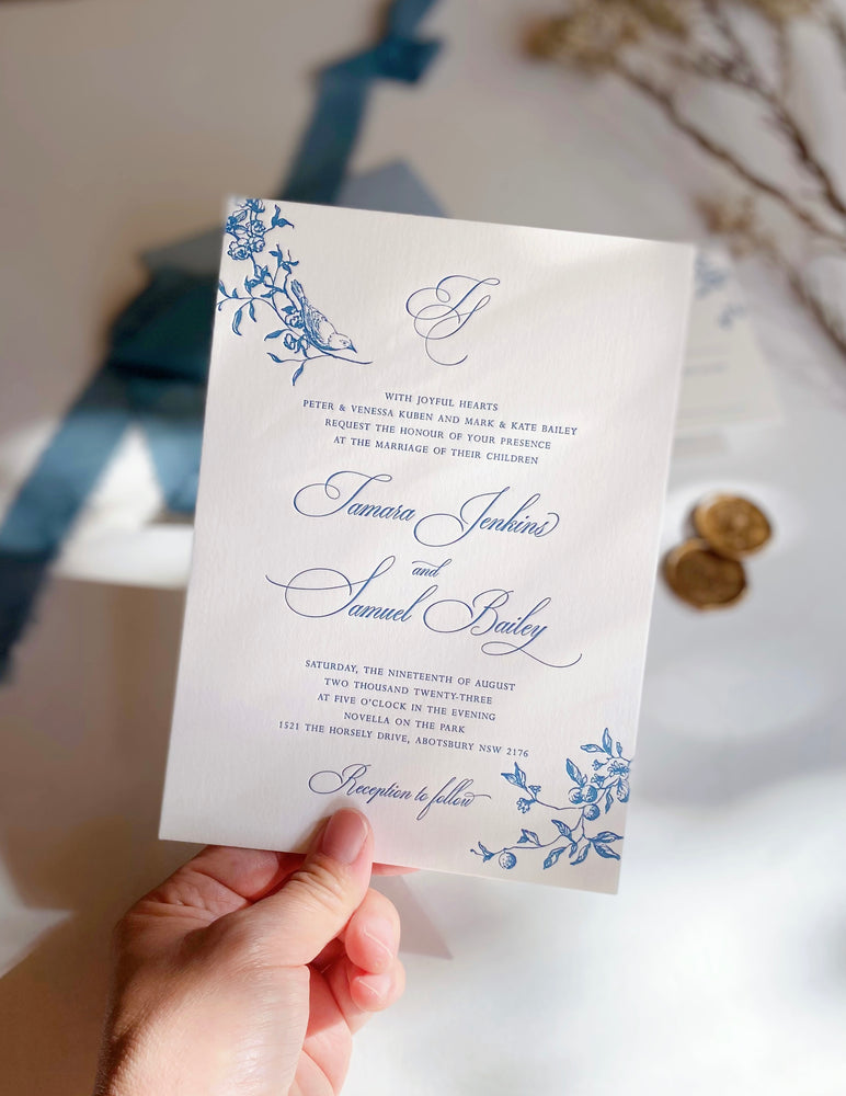 Letterpress Garden Wedding Invitation in blue and white with wax seal and ribbons.