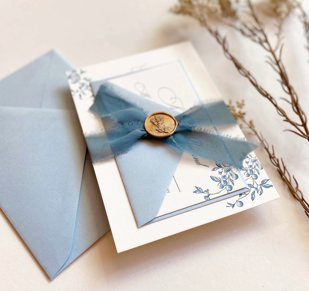 
                  
                    Load image into Gallery viewer, Letterpress Garden Wedding Invitation in blue and white with wax seal and ribbons.
                  
                
