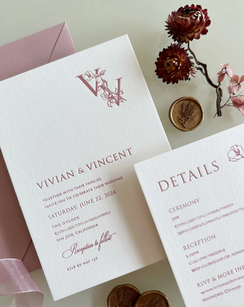 Letterpress wedding invitation with floral personalised monogram in pink.