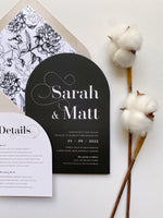 Arch shaped wedding invitation in black and white and neutral colours