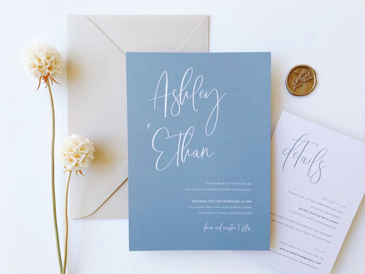 
                  
                    Load image into Gallery viewer, Ashleigh&amp;#39;s Calligraphy Wedding Invitation in dusty blue, printed on 250gsm pearlescent card stock.
                  
                